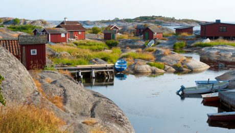 The first rays of the morning sun hit the cottages on a small island in the outer archipelago.